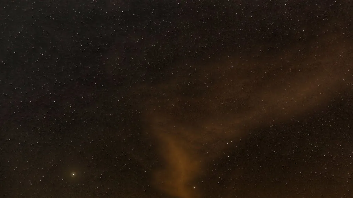 A mesmerizing view of a starry night sky with wispy clouds illuminated softly, perfect for backgrounds.
